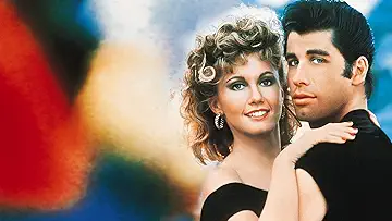 John Travolta as Danny Zuko and Olivia Newton-John as Sandy Olsson close together on the poster for the Grease game.